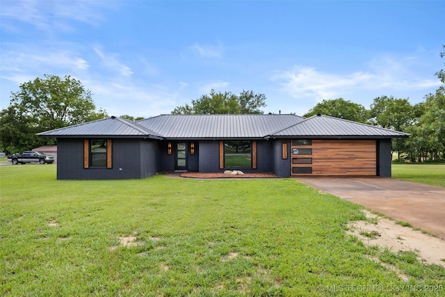 16355 County Road 1586, Ada, OK 74820 - view of front of home featuring concrete driveway, a front lawn, a metal roof, an attached garage, and brick siding