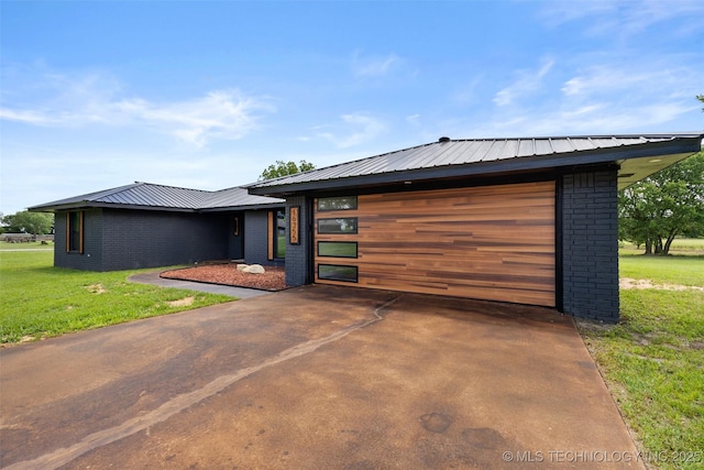 16355 County Road 1586, Ada, OK 74820 - contemporary house with brick siding, a garage, a front yard, and a metal roof