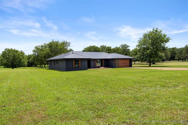 16355 County Road 1586, Ada, OK 74820 - view of front facade featuring concrete driveway, a front yard, a metal roof, and a garage