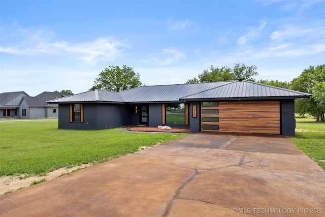 16355 County Road 1586, Ada, OK 74820 - contemporary house with a front lawn, a garage, brick siding, and a metal roof