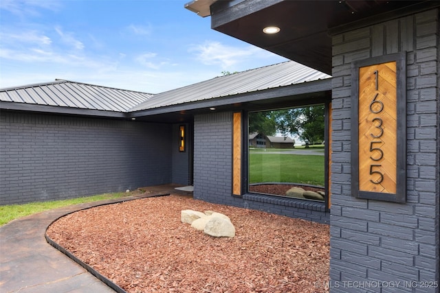16355 County Road 1586, Ada, OK 74820 - property entrance featuring brick siding and a metal roof