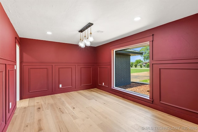 16355 County Road 1586, Ada, OK 74820 - spare room with a decorative wall, light wood-style flooring, a wainscoted wall, and recessed lighting