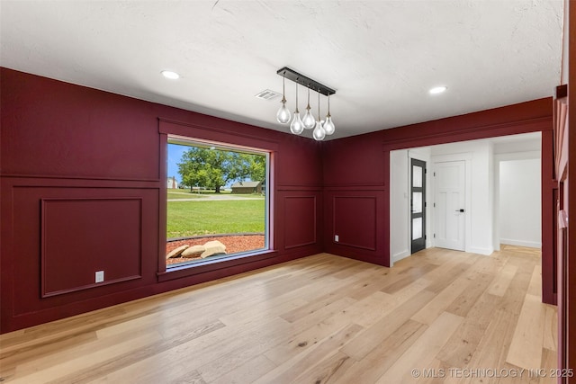 16355 County Road 1586, Ada, OK 74820 - unfurnished dining area with a decorative wall, light wood finished floors, and recessed lighting