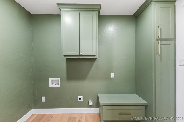 16355 County Road 1586, Ada, OK 74820 - laundry area featuring hookup for an electric dryer, hookup for a washing machine, light wood-type flooring, and cabinet space