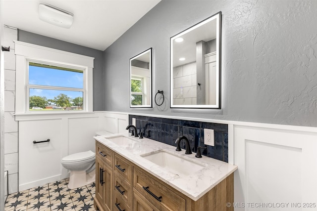 16355 County Road 1586, Ada, OK 74820 - bathroom with tile patterned floors, wainscoting, and double vanity