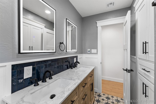 16355 County Road 1586, Ada, OK 74820 - bathroom featuring double vanity and wainscoting