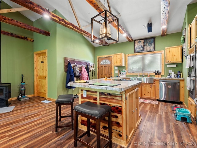 346 2570th Rd, Bartlesville, OK 74003 - kitchen with stainless steel appliances, wood finished floors, light countertops, a kitchen island, and vaulted ceiling
