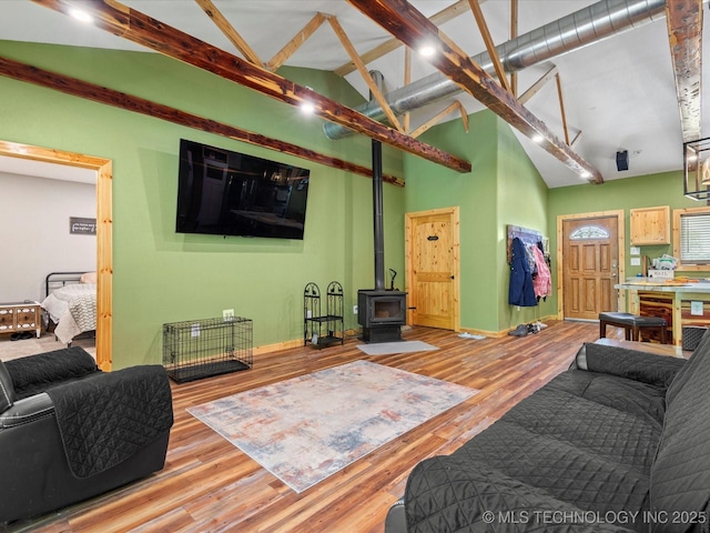 346 2570th Rd, Bartlesville, OK 74003 - living room with a wood stove, wood finished floors, beamed ceiling, and high vaulted ceiling