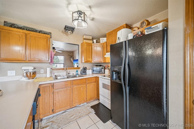 2 Ketchum St, Chelsea, OK 74016 - kitchen featuring black appliances, light tile patterned flooring, and light countertops