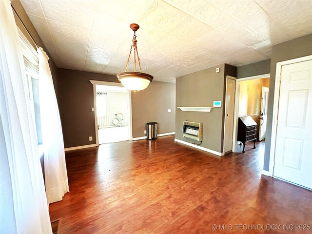 5371 Hilltop, Mcalester, OK 74501 - unfurnished living room with heating unit, wood finished floors, and a glass covered fireplace