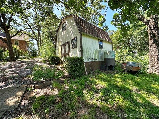 5371 Hilltop, Mcalester, OK 74501 - view of home's exterior featuring a shingled roof and a gambrel roof
