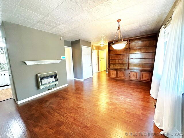 5371 Hilltop, Mcalester, OK 74501 - unfurnished living room with heating unit, wood finished floors, and built in features