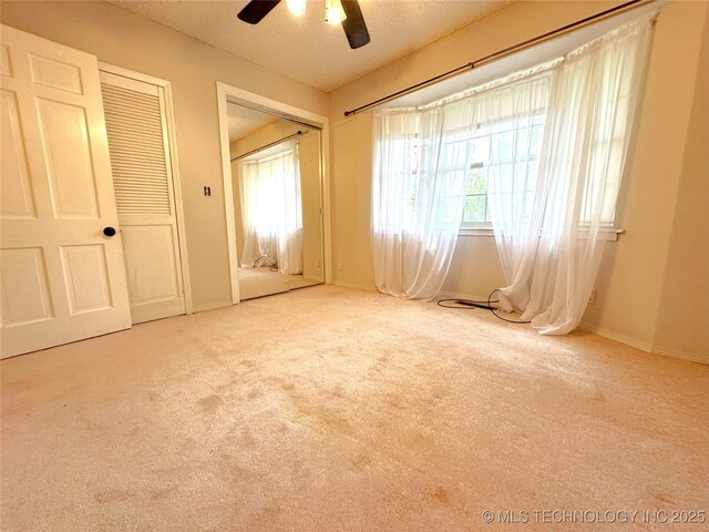 5371 Hilltop, Mcalester, OK 74501 - unfurnished bedroom featuring carpet, two closets, and a ceiling fan
