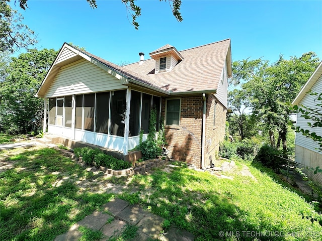 5371 Hilltop, Mcalester, OK 74501 - back of property with a sunroom, brick siding, a lawn, and roof with shingles