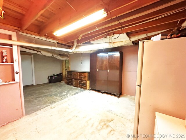 5371 Hilltop, Mcalester, OK 74501 - unfinished below grade area featuring freestanding refrigerator