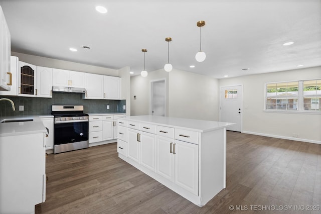 1103 S Choctaw Pl, Claremore, OK 74017 - kitchen with stainless steel gas range oven, under cabinet range hood, dark wood-style flooring, a center island, and recessed lighting
