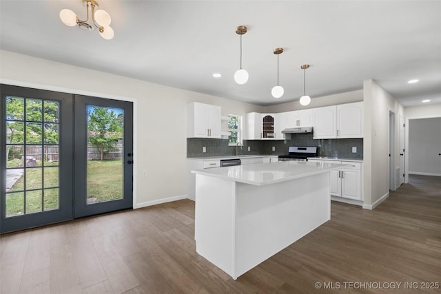 1103 S Choctaw Pl, Claremore, OK 74017 - kitchen with range with electric cooktop, under cabinet range hood, dark wood-style floors, light countertops, and recessed lighting