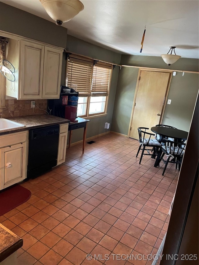 2509 Canterbury Ave, Muskogee, OK 74403 - kitchen with dishwasher, light tile patterned floors, decorative backsplash, and cream cabinets