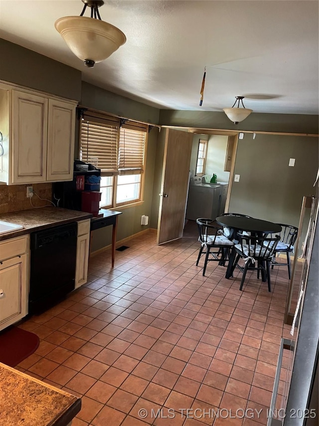 2509 Canterbury Ave, Muskogee, OK 74403 - kitchen featuring dishwasher, separate washer and dryer, cream cabinets, and light tile patterned floors