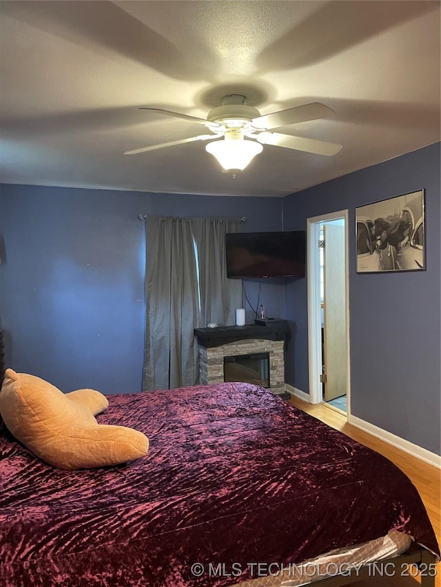 2509 Canterbury Ave, Muskogee, OK 74403 - bedroom with wood finished floors, a ceiling fan, and a fireplace