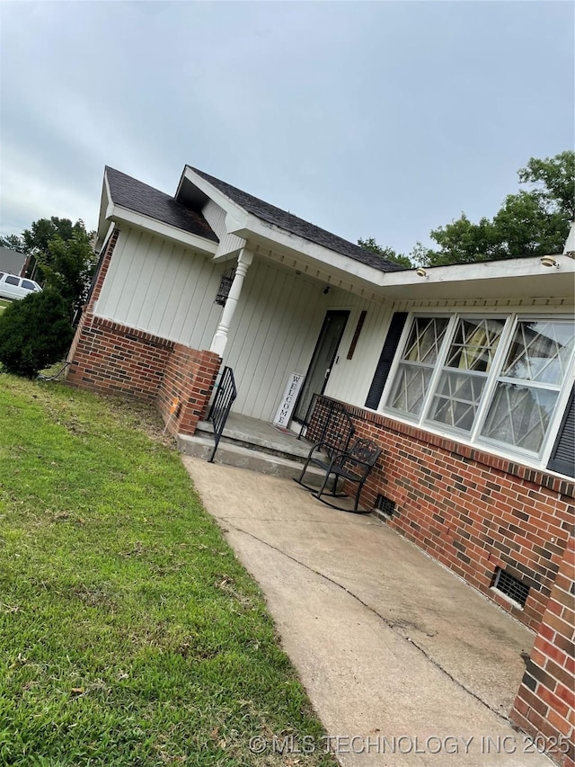 2509 Canterbury Ave, Muskogee, OK 74403 - property entrance with brick siding and a yard