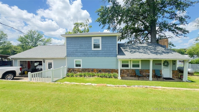 1060 Lakeside Dr, Fort Towson, OK 74735 - view of front facade featuring an attached garage, stone siding, and a chimney