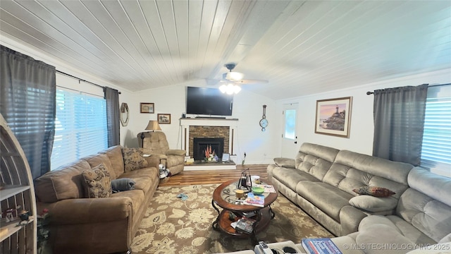 1060 Lakeside Dr, Fort Towson, OK 74735 - living room with ceiling fan, a stone fireplace, vaulted ceiling, wooden ceiling, and wood finished floors