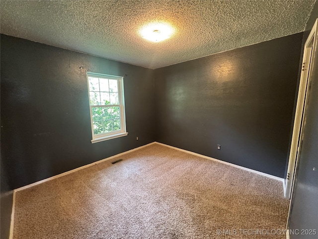 1516 Timber Ridge Dr, Cleveland, OK 74020 - carpeted spare room with a textured ceiling and baseboards
