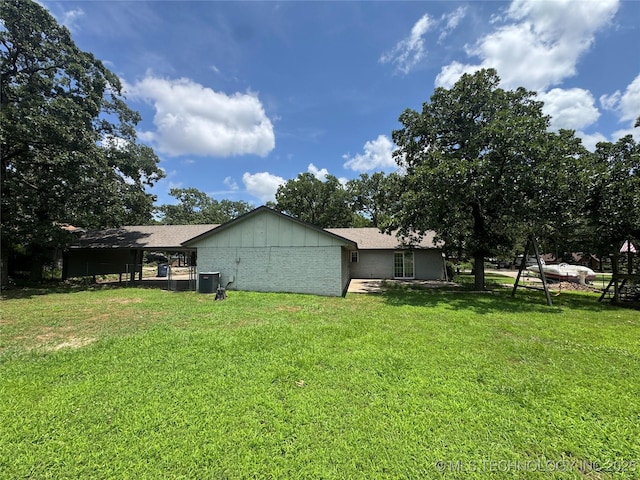 1516 Timber Ridge Dr, Cleveland, OK 74020 - rear view of house featuring a lawn