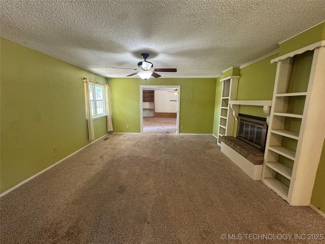 1516 Timber Ridge Dr, Cleveland, OK 74020 - unfurnished living room with a glass covered fireplace, carpet flooring, ceiling fan, and a textured ceiling