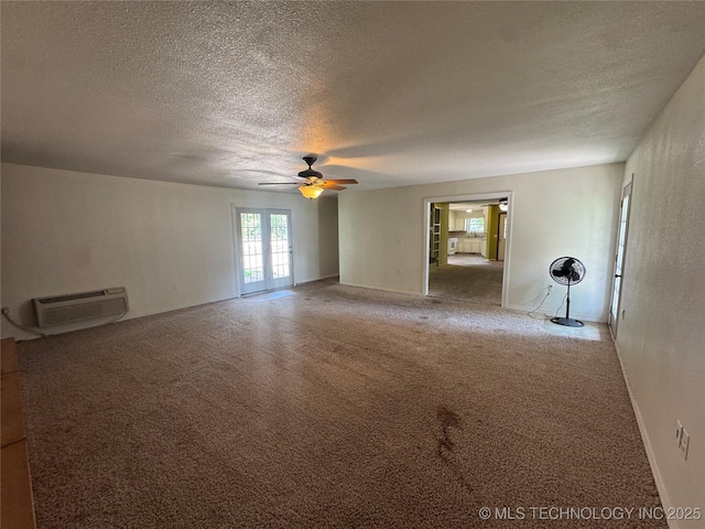 1516 Timber Ridge Dr, Cleveland, OK 74020 - carpeted empty room featuring a ceiling fan, a textured ceiling, a wall mounted AC, and french doors