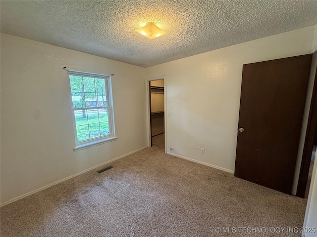 1516 Timber Ridge Dr, Cleveland, OK 74020 - unfurnished bedroom featuring carpet, a textured ceiling, and a closet