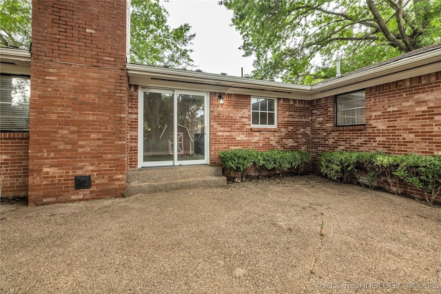 5941 S Utica Ave, Tulsa, OK 74105 - rear view of property featuring a chimney, brick siding, and entry steps