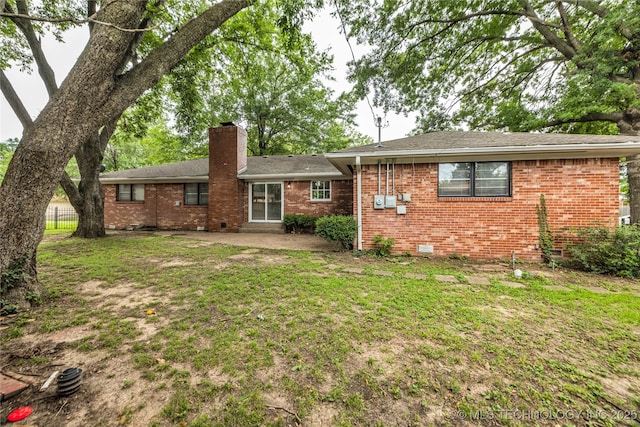 5941 S Utica Ave, Tulsa, OK 74105 - rear view of house with a chimney, brick siding, a patio area, and roof with shingles