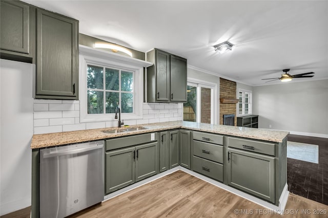 5941 S Utica Ave, Tulsa, OK 74105 - kitchen featuring stainless steel dishwasher, a peninsula, decorative backsplash, light wood-type flooring, and ornamental molding