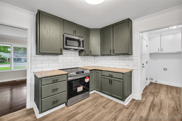 5941 S Utica Ave, Tulsa, OK 74105 - kitchen with appliances with stainless steel finishes, ornamental molding, light wood-style flooring, backsplash, and light stone counters