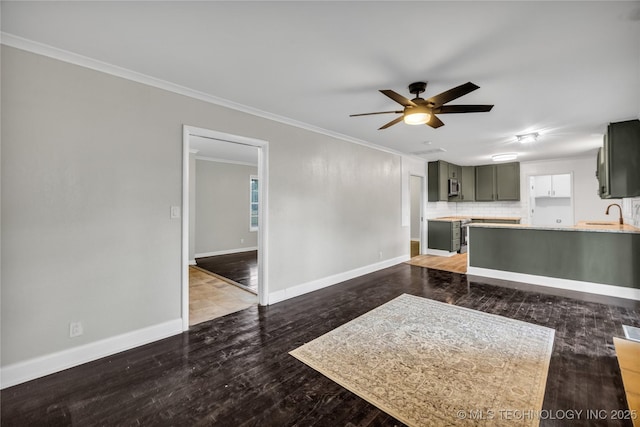 5941 S Utica Ave, Tulsa, OK 74105 - unfurnished living room with ceiling fan, wood finished floors, and crown molding