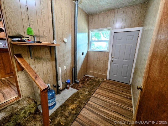 6850 E County Road 553, Kansas, OK 74347 - entrance foyer featuring wooden walls, wood finished floors, and a textured ceiling