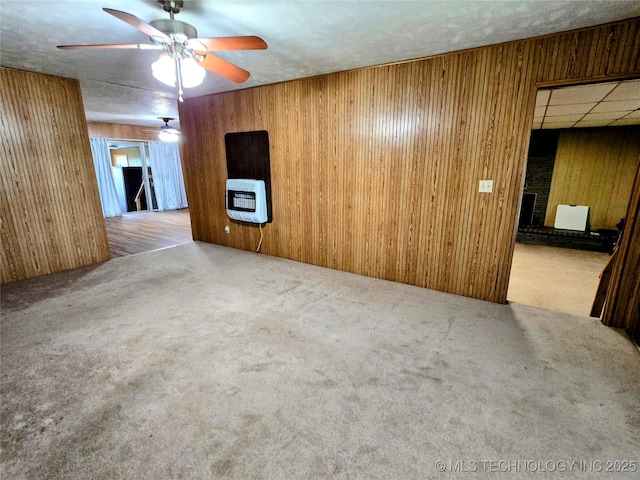6850 E County Road 553, Kansas, OK 74347 - spare room featuring heating unit, wooden walls, ceiling fan, and carpet flooring