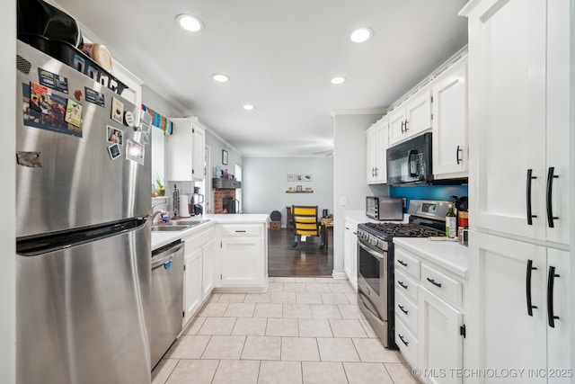1508 S Kalanchoe Ave, Broken Arrow, OK 74012 - kitchen featuring stainless steel appliances, recessed lighting, crown molding, white cabinets, and light countertops