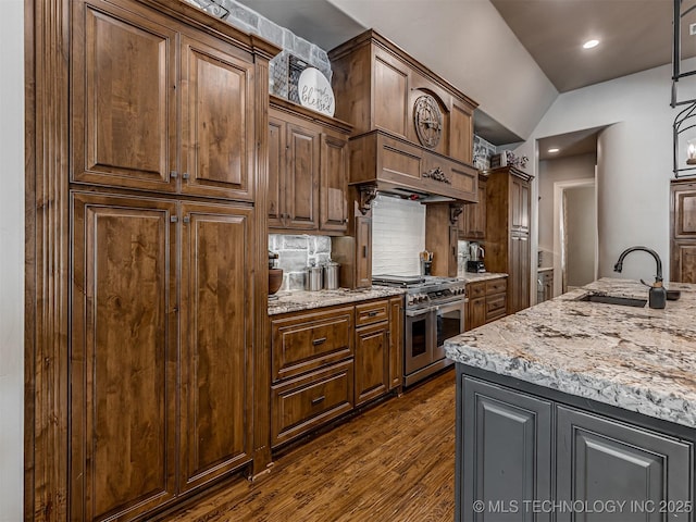 10741 S 93rd E Ave, Tulsa, OK 74133 - kitchen with double oven range, dark wood-style floors, vaulted ceiling, tasteful backsplash, and light stone counters