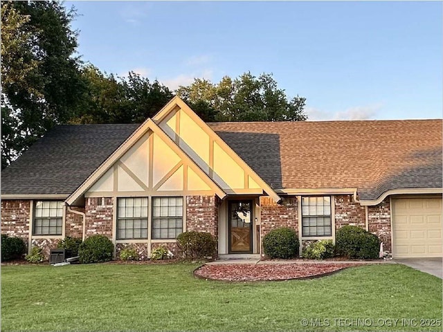 9927 S Irvington Ave, Tulsa, OK 74137 - english style home with a garage, a front lawn, brick siding, a shingled roof, and concrete driveway