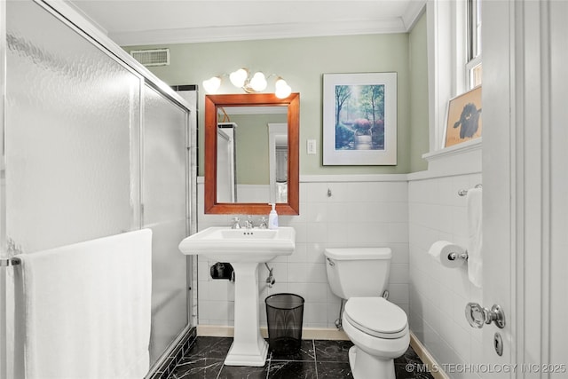 1500 S Frisco Ave Unit 1E, Tulsa, OK 74119 - bathroom featuring marble finish floors, ornamental molding, wainscoting, and a shower with shower door
