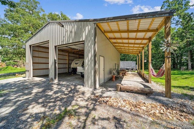 16 Big Bluff St, Pryor, OK 74361 - view of vehicle parking featuring a detached garage and a pole building