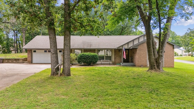 16 Big Bluff St, Pryor, OK 74361 - view of front of home with an attached garage, concrete driveway, a front yard, and brick siding
