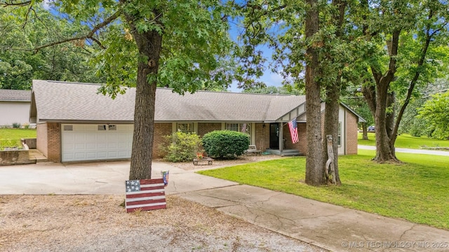 16 Big Bluff St, Pryor, OK 74361 - view of front of house with driveway, a garage, a front lawn, and brick siding
