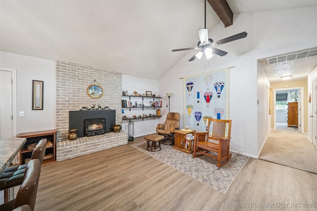16 Big Bluff St, Pryor, OK 74361 - sitting room featuring wood finished floors, beam ceiling, a ceiling fan, a fireplace, and high vaulted ceiling