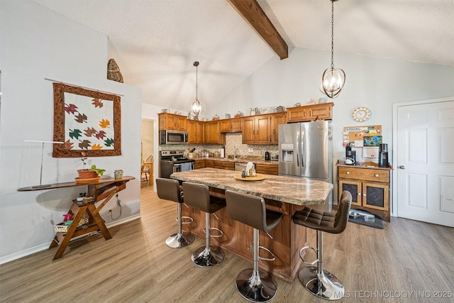 16 Big Bluff St, Pryor, OK 74361 - kitchen with stainless steel appliances, light wood-style floors, beamed ceiling, a chandelier, and brown cabinetry