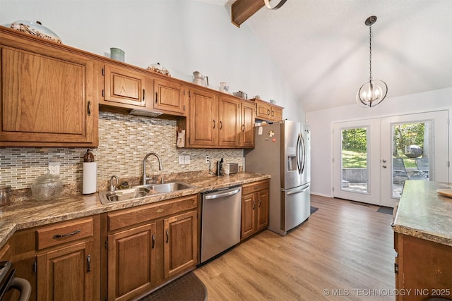 16 Big Bluff St, Pryor, OK 74361 - kitchen with appliances with stainless steel finishes, beam ceiling, tasteful backsplash, light wood-style floors, and brown cabinets