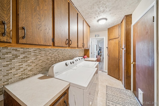 16 Big Bluff St, Pryor, OK 74361 - washroom with washing machine and clothes dryer, a textured ceiling, and cabinet space
